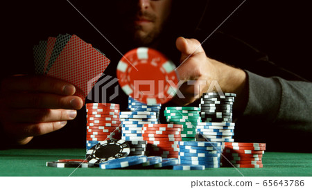 Poker player throwing chip Poker player throwing chip 65643786