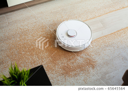 Robot vacuum cleaner performs automatic cleaning of the apartment at a certain time. Smart home. 65645564