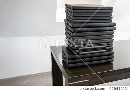 Stack of laptop computers: Laptops are used and second hand, might be for people in need due to working from home or home schooling during Corona Crisis. Stack of laptop computers: Laptops are used and second hand, might be for people in need due to working from home or home schooling during Corona Crisis. 65645933