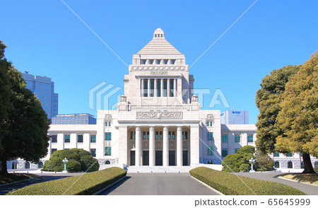 A bright, cloudless parliament building. "Truth, justice, equality" 65645999