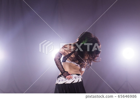 Spirituality dance. Beautiful sexy woman with luxury glossy eastern make-up dancing tribal fusion. Belly dance. Spirituality dance. Beautiful sexy woman with luxury glossy eastern make-up dancing tribal fusion. Belly dance. 65646986
