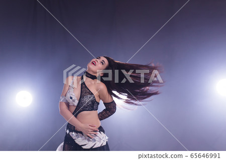Spirituality dance. Beautiful sexy woman with luxury glossy eastern make-up dancing tribal fusion. Belly dance. 65646991