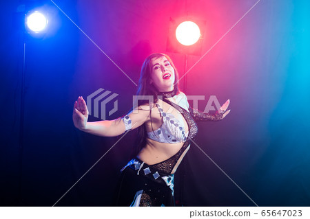 Spirituality dance. Beautiful sexy woman with luxury glossy eastern make-up dancing tribal fusion. Belly dance. Spirituality dance. Beautiful sexy woman with luxury glossy eastern make-up dancing tribal fusion. Belly dance. 65647023