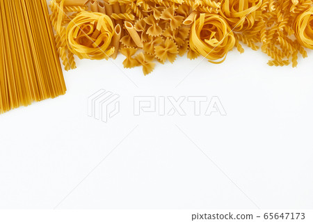 various uncooked pasta on white background. Top view. various uncooked pasta on white background. Top view. 65647173