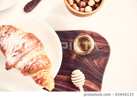 Coffee and croissant with honey. French breakfast. Top view flat lay with copy space for your text Coffee and croissant with honey. French breakfast. Top view flat lay with copy space for your text 65648133