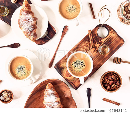 breakfast pattern, croissant, coffee, honey, cinnamon sticks, nuts, sugar. Good morning concept. breakfast pattern, croissant, coffee, honey, cinnamon sticks, nuts, sugar. Good morning concept. 65648141