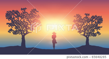 summer girl on a sunny day stands between two trees by the ocean summer girl on a sunny day stands between two trees by the ocean 65648285