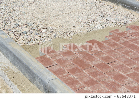 Process of construction of brick paved sidewalk, 65648371
