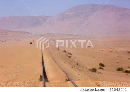 Abandoned and forgotten railway being taken over by encroaching sandstorm, Kolmanskop ghost town, Namib Desert. Africa 65648441