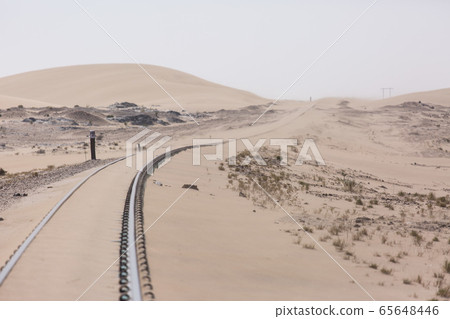 Abandoned and forgotten railway being taken over by encroaching sandstorm, Kolmanskop ghost town, Namib Desert. Africa Abandoned and forgotten railway being taken over by encroaching sandstorm, Kolmanskop ghost town, Namib Desert. Africa 65648446