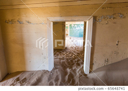 Abandoned and forgotten building and room left by people and being taken over by encroaching sandstorm, Kolmanskop ghost town, Namib Desert Abandoned and forgotten building and room left by people and being taken over by encroaching sandstorm, Kolmanskop ghost town, Namib Desert 65648741