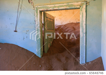 Abandoned and forgotten building and room left by people and being taken over by encroaching sandstorm, Kolmanskop ghost town, Namib Desert Abandoned and forgotten building and room left by people and being taken over by encroaching sandstorm, Kolmanskop ghost town, Namib Desert 65648746