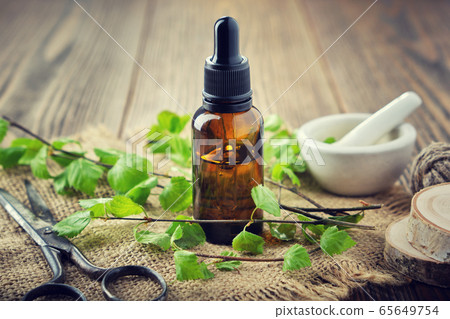 Bottle of birch essential oil, tincture, coal tar. Bottle of birch essential oil, tincture, coal tar. 65649754