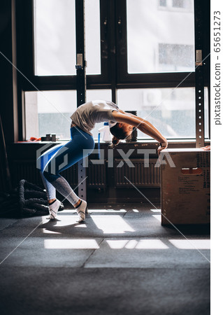 Portrait of attractive young woman doing yoga or pilates exercise Portrait of attractive young woman doing yoga or pilates exercise 65651273