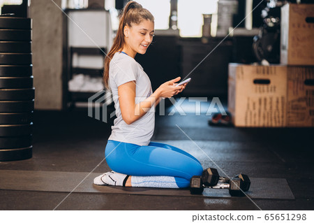 Portrait of attractive young woman doing yoga or pilates exercise 65651298