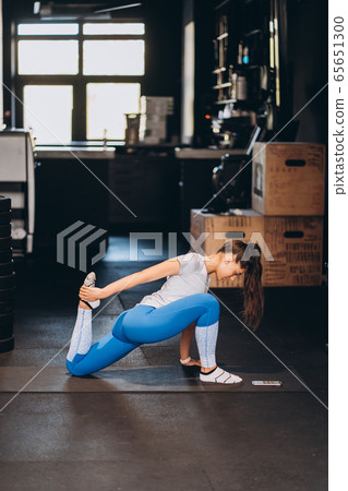 Portrait of attractive young woman doing yoga or pilates exercise 65651300