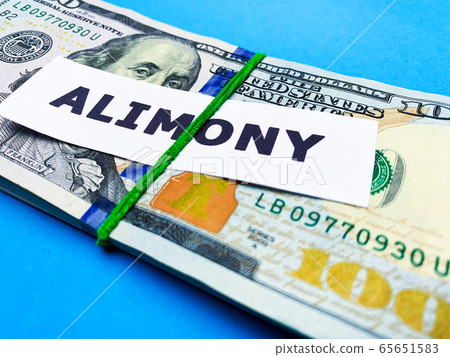 Concept of paying alimony, stack of money on the table Concept of paying alimony, stack of money on the table 65651583