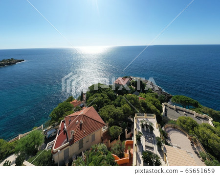 France, Cote Dazur, Beaulieu, 02 October 2019: Aerial view of French Riviera's terraces of expensive country houses and estates, palm trees, pools, haise lounges 65651659