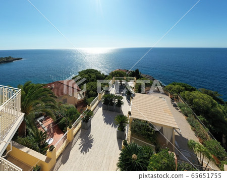 France, Cote Dazur, Beaulieu, 02 October 2019: Aerial view of French Riviera's terraces of expensive country houses and estates, palm trees, pools, haise lounges 65651755
