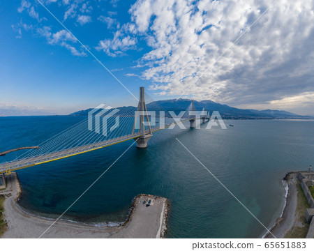 Aerial view of long cable-stayed Rio bridge in Greece at clouds weather, Ferry station 65651883