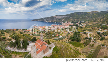 Aerial panoramic view of the cathedral St.Nicholas in Komiza city - the one of numerous port towns in Croatia, orange roofs of houses, picturisque bay, mountain is on background Aerial panoramic view of the cathedral St.Nicholas in Komiza city - the one of numerous port towns in Croatia, orange roofs of houses, picturisque bay, mountain is on background 65651980