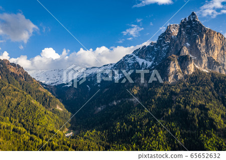 Aerial view of improbable peak of mountains of Dolomites at sunset, Italian Alps, Bolzano 65652632