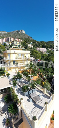 France, Cote Dazur, Beaulieu, 02 October 2019: Aerial view of French Riviera's terraces of expensive country houses and estates, palm trees, pools, haise lounges 65652854