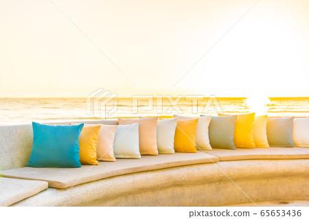 Comfortable pillow on sofa chair around outdoor patio with sea ocean beach view Comfortable pillow on sofa chair around outdoor patio with sea ocean beach view 65653436
