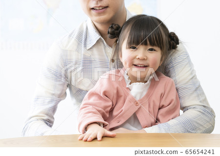 5-year-old girl held by her father 5-year-old girl held by her father 65654241