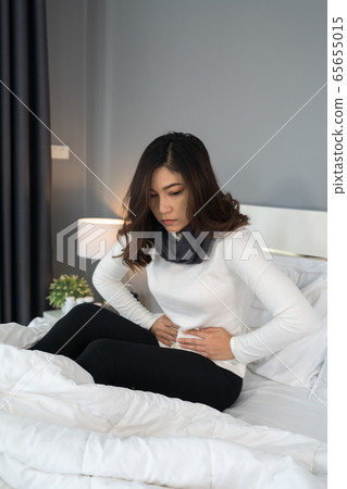 woman with stomach ache in bed woman with stomach ache in bed 65655015