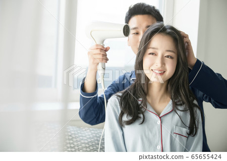 Couple, hair dryer, pajamas 65655424