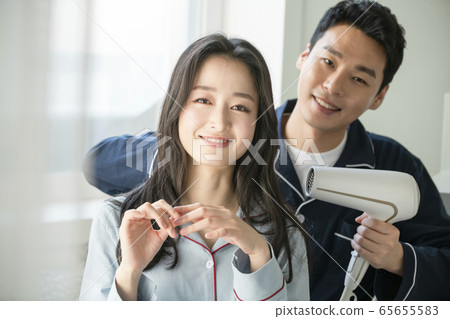 Couple, hair dryer, pajamas 65655583