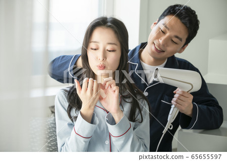 Couple, hair dryer, pajamas 65655597