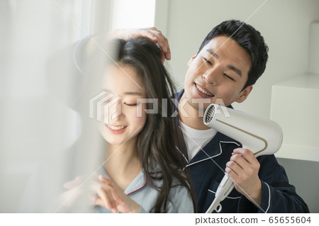 Couple, hair dryer, pajamas 65655604