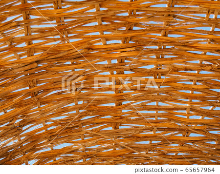 Beach umbrella made of yellow reed, close up view Beach umbrella made of yellow reed, close up view 65657964