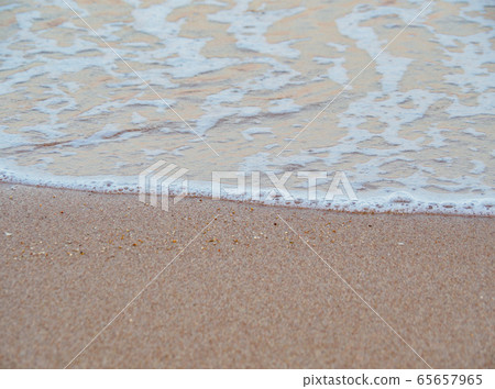 White sea foam on brown sand, close up view White sea foam on brown sand, close up view 65657965