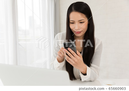 A woman operating a smartphone A woman operating a smartphone 65660903