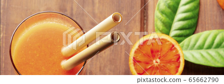 Reusable bamboo straw panorama on a rustic wooden background, fresh orange juice with blood oranges, shot from above, selective focus Reusable bamboo straw panorama on a rustic wooden background, fresh orange juice with blood oranges, shot from above, selective focus 65662790