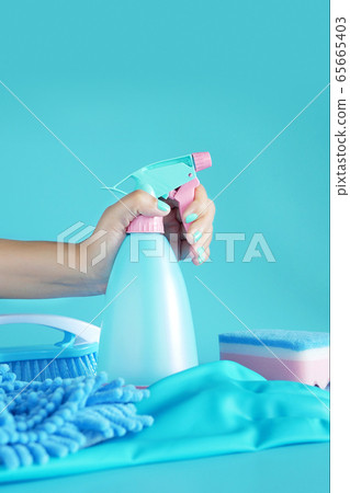 woman hand holding cleaning spray blue plastic bottle detergent isolated on blue background with cleaning tools product supplies woman hand holding cleaning spray blue plastic bottle detergent isolated on blue background with cleaning tools product supplies 65665403