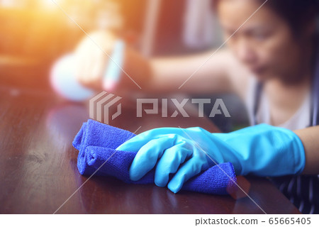 hand in blue rubber glove holding blue microfiber cleaning cloth and spray bottle with sterilizing solution make cleaning and disinfection for good hygiene hand in blue rubber glove holding blue microfiber cleaning cloth and spray bottle with sterilizing solution make cleaning and disinfection for good hygiene 65665405