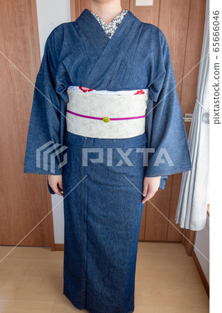 Front view of woman wearing indigo blue denim kimono Front view of woman wearing indigo blue denim kimono 65666046