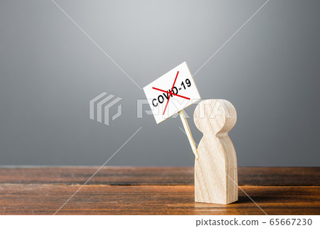 A person with a poster protests against quarantine measures. Conspiracy theories followers. Denial of the existence of the virus. The result of a hybrid information war and the manipulation of facts. A person with a poster protests against quarantine measures. Conspiracy theories followers. Denial of the existence of the virus. The result of a hybrid information war and the manipulation of facts. 65667230