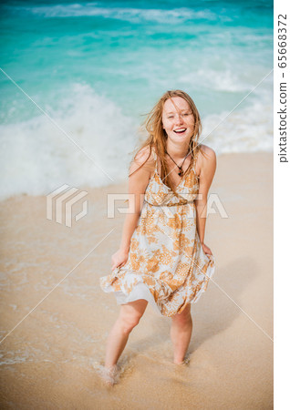 The girl walks on the water's edge on the Boracay 65668372