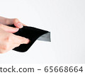 Close-up of empty wallet in hands isolated on white. 65668664