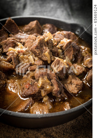 Beef stew in a cast iron skillet. Beef stew in a cast iron skillet. 65669124
