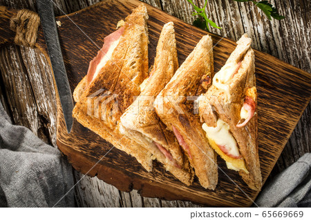 Grilled cheese sandwich on cutting board. 65669669