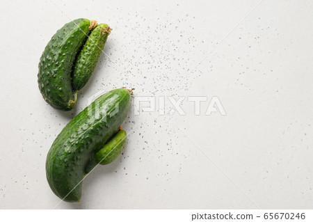 Ugly two cucumbers. Concept organic vegetables. Ugly two cucumbers. Concept organic vegetables. 65670246