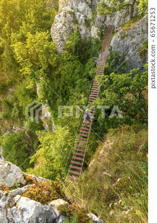 Man Walking on Via Ferrata Trail 65671253