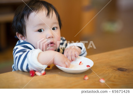 Infant eating snack Infant eating snack 65671426