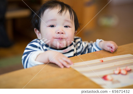 Infant eating snack Infant eating snack 65671432